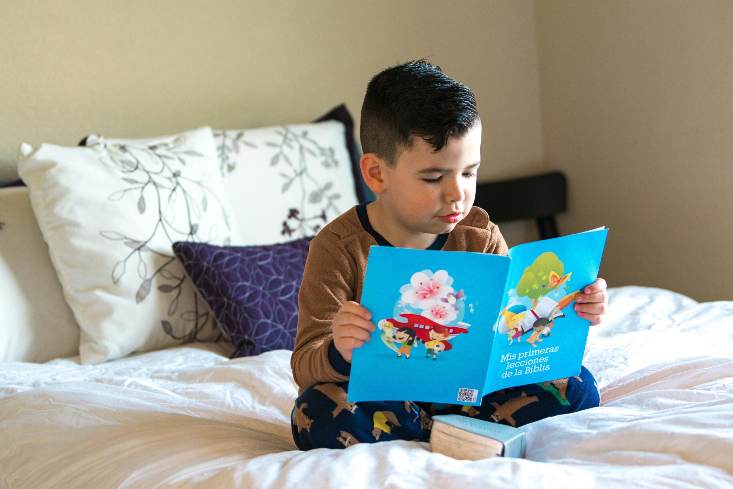 Photo of Liam smiling next to his tablet displaying the Ghotit app.
